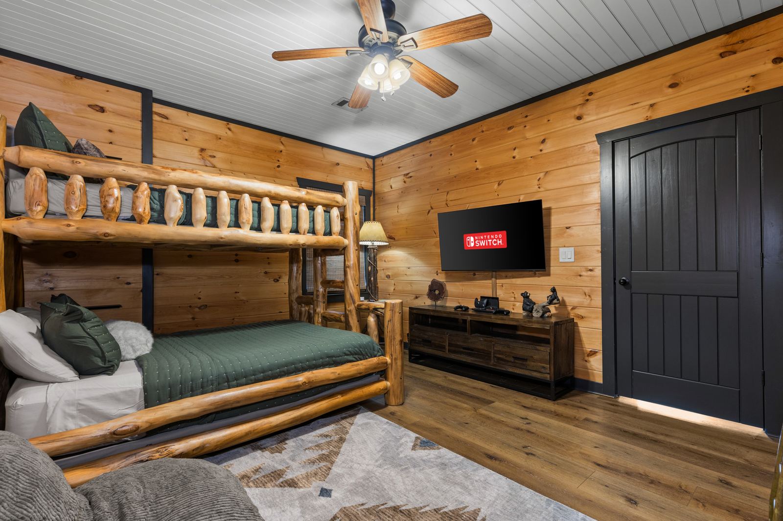 The bunk room, with its twin-over-full log bunk and floor cushions