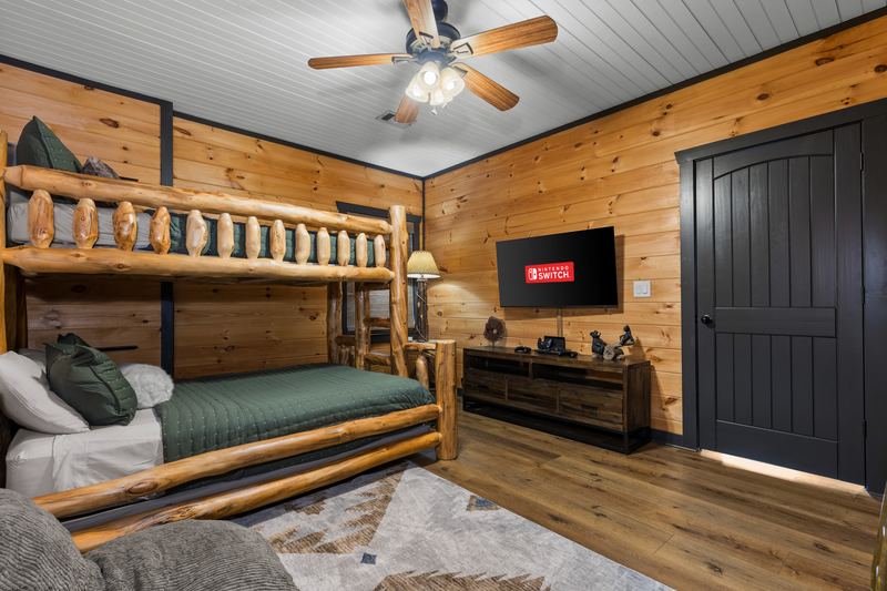 The bunk room, with its twin-over-full log bunk and floor cushions