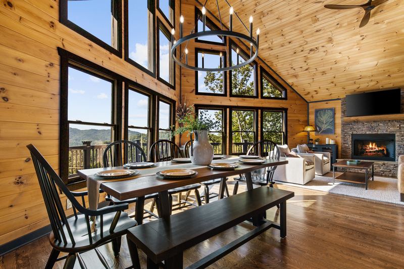 The farmhouse dining table with benches, beside the windows
