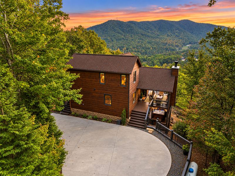 The paved driveway and parking area at dusk