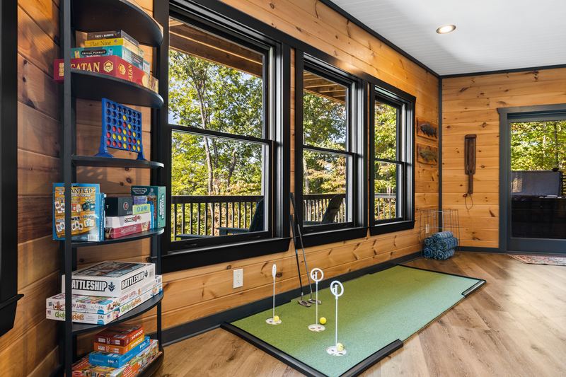 Board games on the shelf beside the putting green