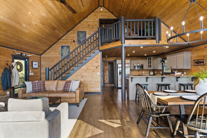 The great room, the dining table and the stairs up to the loft