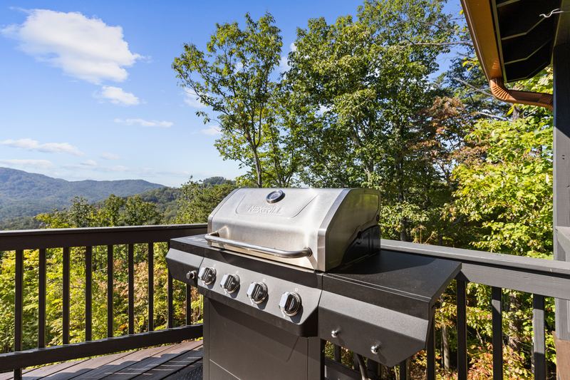 The gas grill on the deck, with the mountains beyond