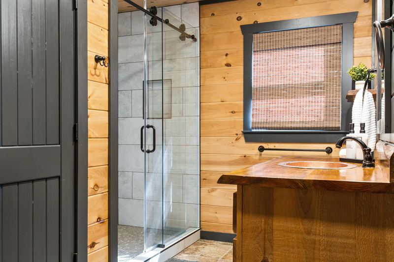 The renovated guest bath's glass-door walk-in shower