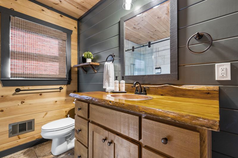 The guest bath's live-edge vanity and copper sink