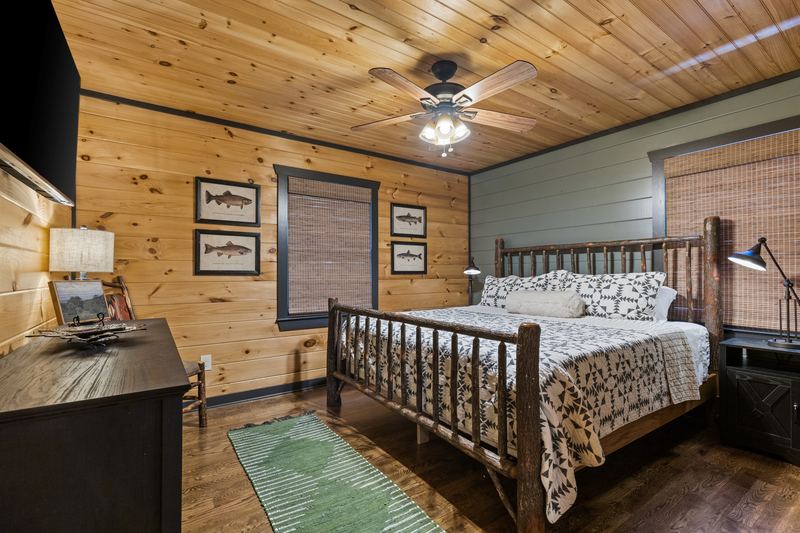 The main-level guest bedroom with a log king bed