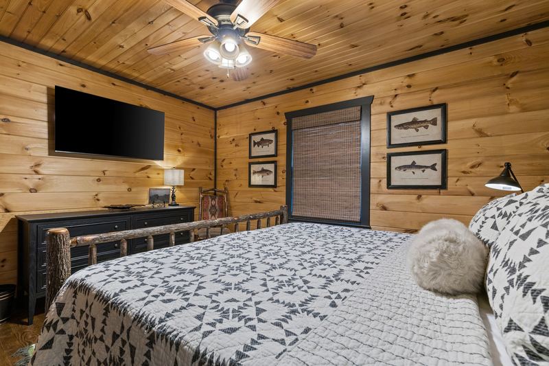 The guest bedroom's king bed and TV