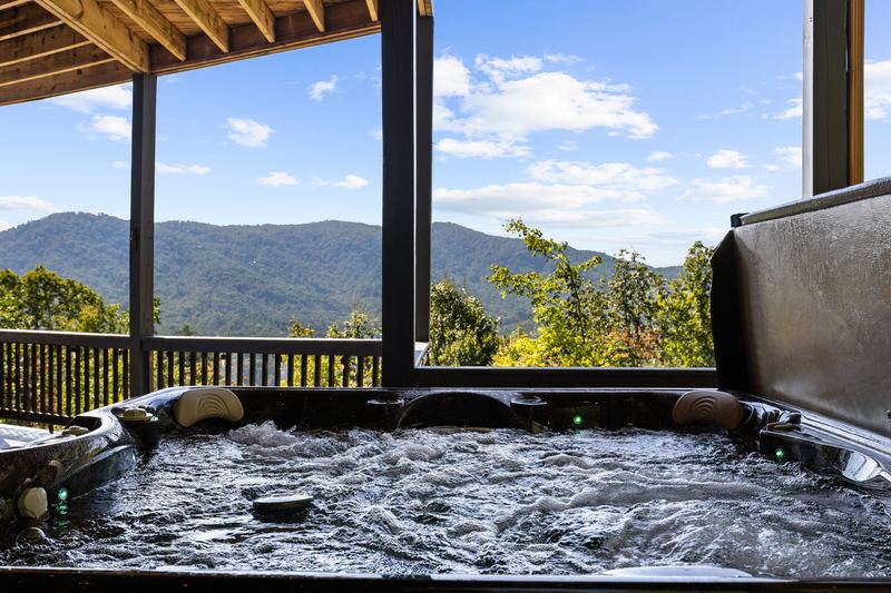 The hot tub on the covered deck, looking out to the mountains