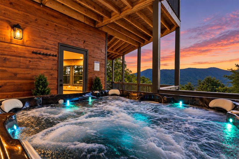 The covered hot tub at dusk, with the mountains behind it