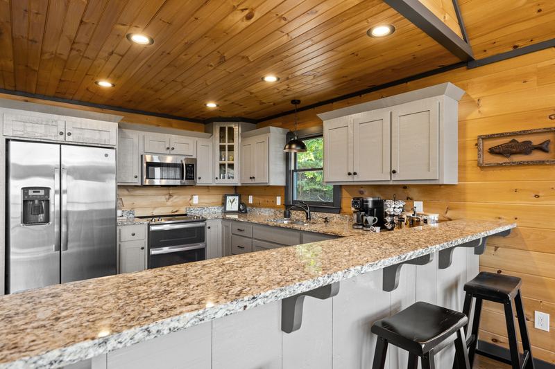 The kitchen and the granite breakfast bar
