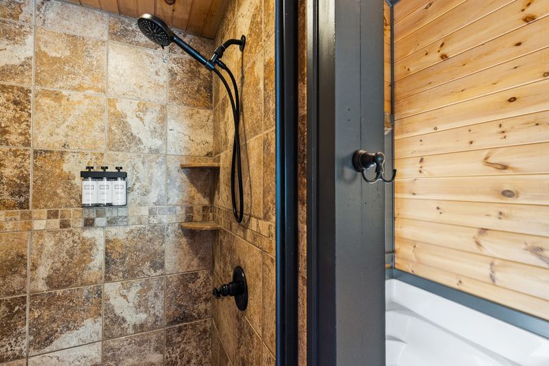 The primary bath's tiled walk-in shower