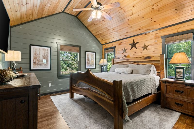 The primary bedroom's king bed under the vaulted ceiling