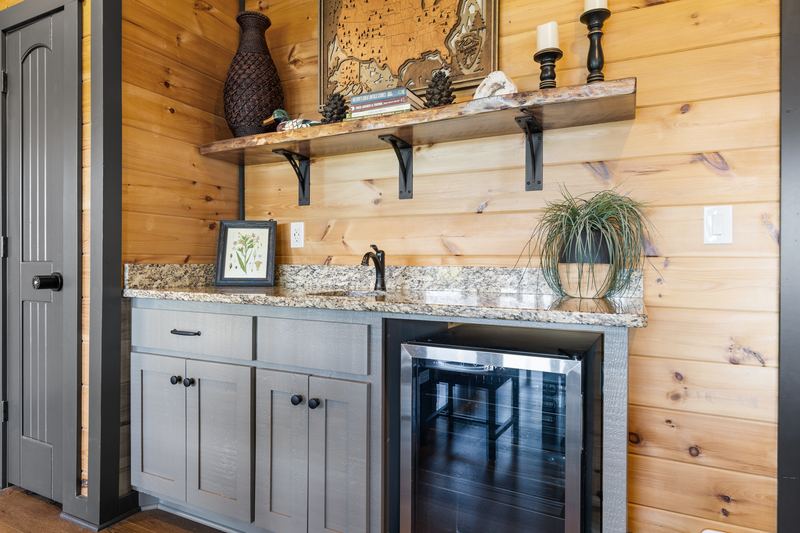 The wet bar with a sink and beverage fridge